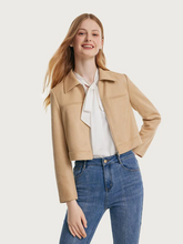a lady in faux suede cropped jacket with jeans and white shirt